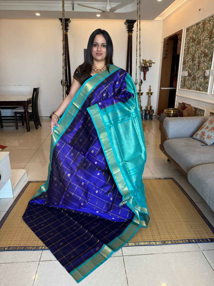 Dark Blue with Light Blue , rich Zari checks in the body with zari butta , ,traditional borders and rich Pallu korvai Silk Cotton Saree