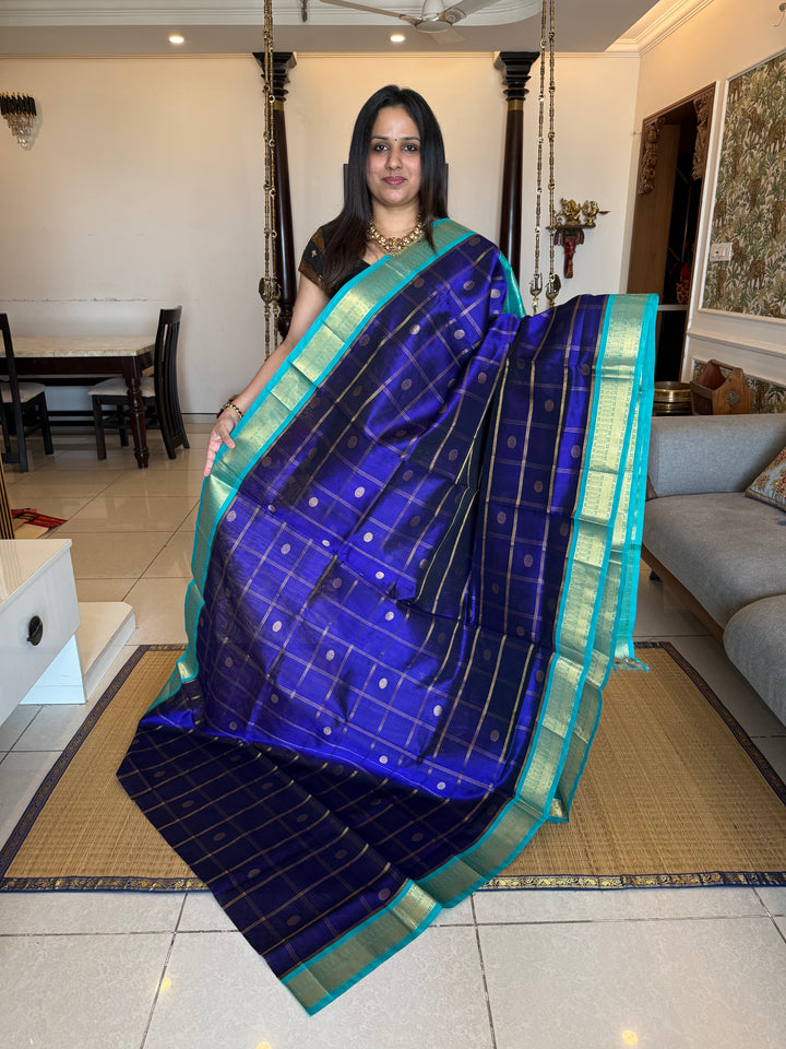 Dark Blue with Light Blue , rich Zari checks in the body with zari butta , ,traditional borders and rich Pallu korvai Silk Cotton Saree