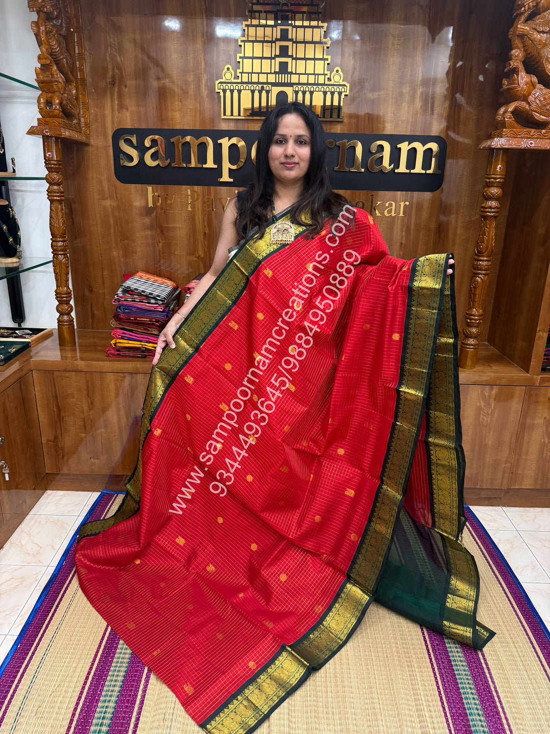 Red with Green , Rich Zari checks in the body , Mayil and Chakram rich butta in the body , Rettapet border and Grand Pallu Korvai Silk Cotton Saree