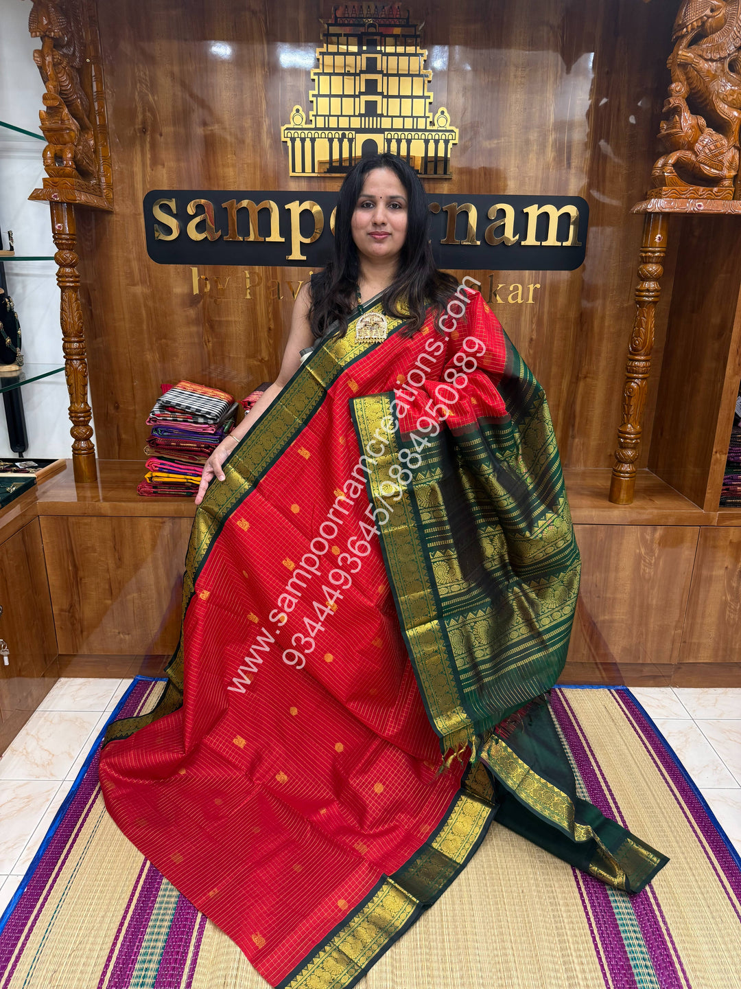 Red with Green , Rich Zari checks in the body , Mayil and Chakram rich butta in the body , Rettapet border and Grand Pallu Korvai Silk Cotton Saree
