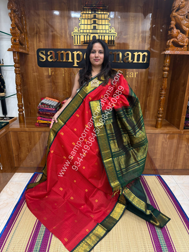 Red with Green , Rich Zari checks in the body , Mayil and Chakram rich butta in the body , Rettapet border and Grand Pallu Korvai Silk Cotton Saree