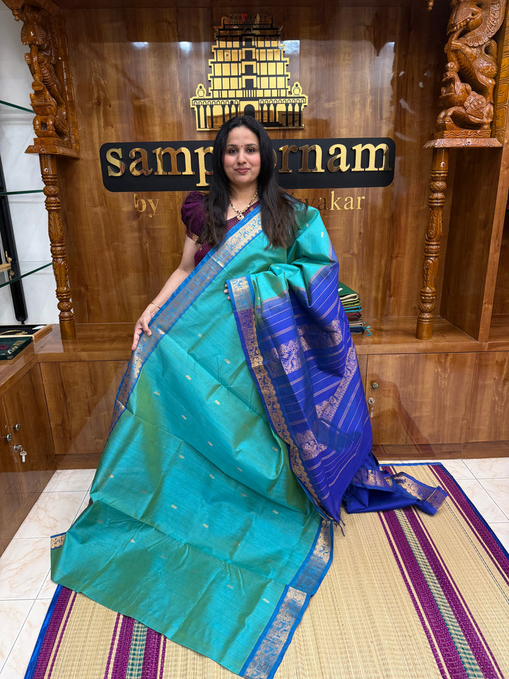 Light Blue with Blue  ,  Rich Mango Zari butta in the body , Traditional Borders and Rich Pallu Silk Cotton Saree