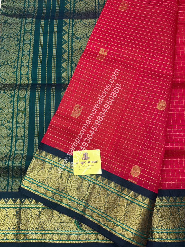 Red with Green , Rich Zari checks in the body , Mayil and Chakram rich butta in the body , Rettapet border and Grand Pallu Korvai Silk Cotton Saree