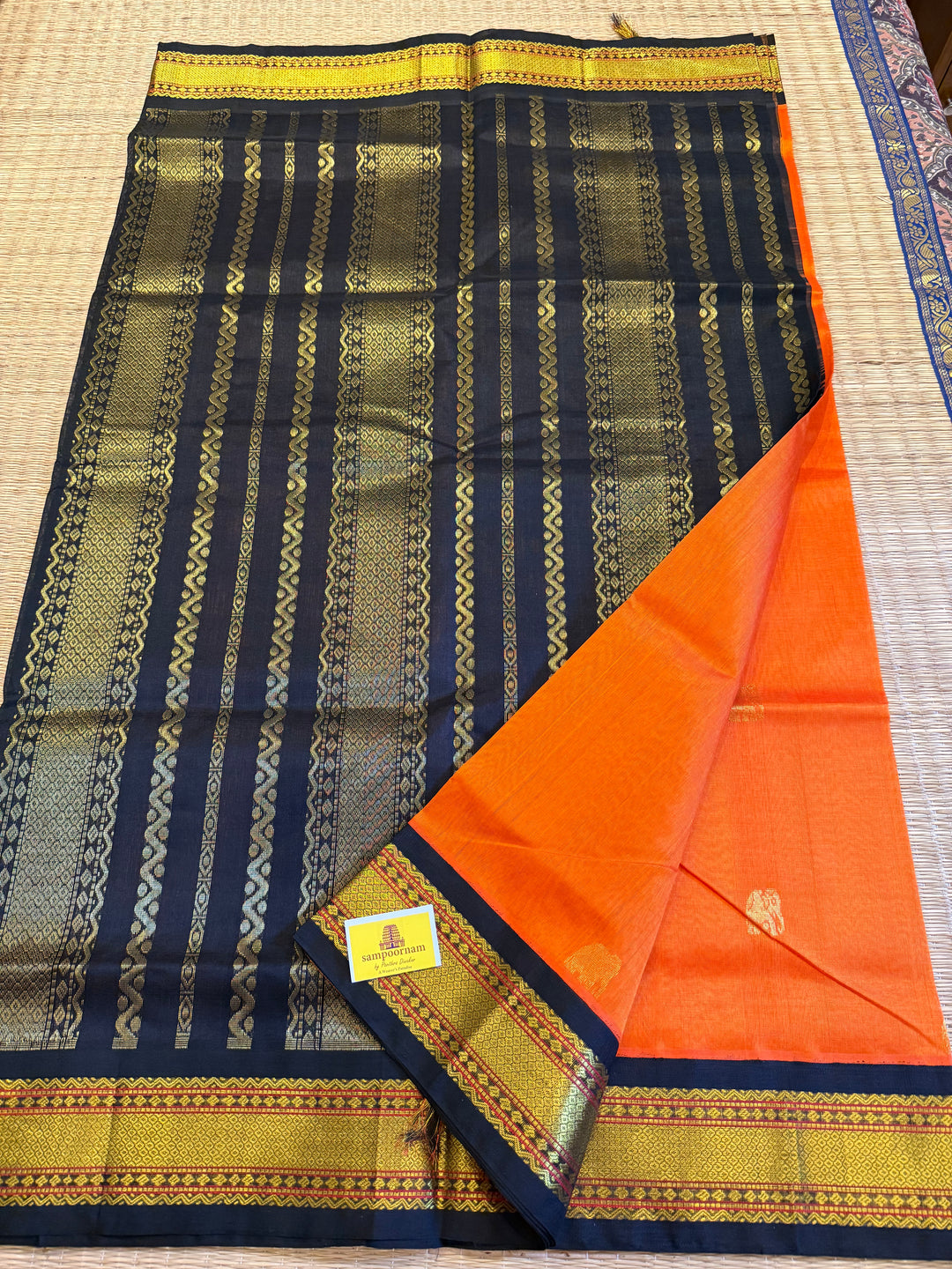 Orange with Black , rich elephant Zari motif in the body , traditional borders and rich Pallu  Korvai Silk Cotton Saree