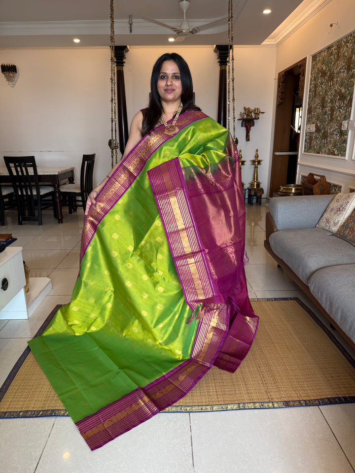 Parrot Green with Purple , rich Zari butta in the body , traditional rich Kanchi borders  and grand Pallu  Korvai Silk Cotton Saree