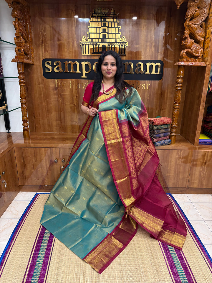 Sage Green with Maroon , Rich Lotus Butta in the body , Traditional borders and rich Pallu Korvai Silk Cotton Saree