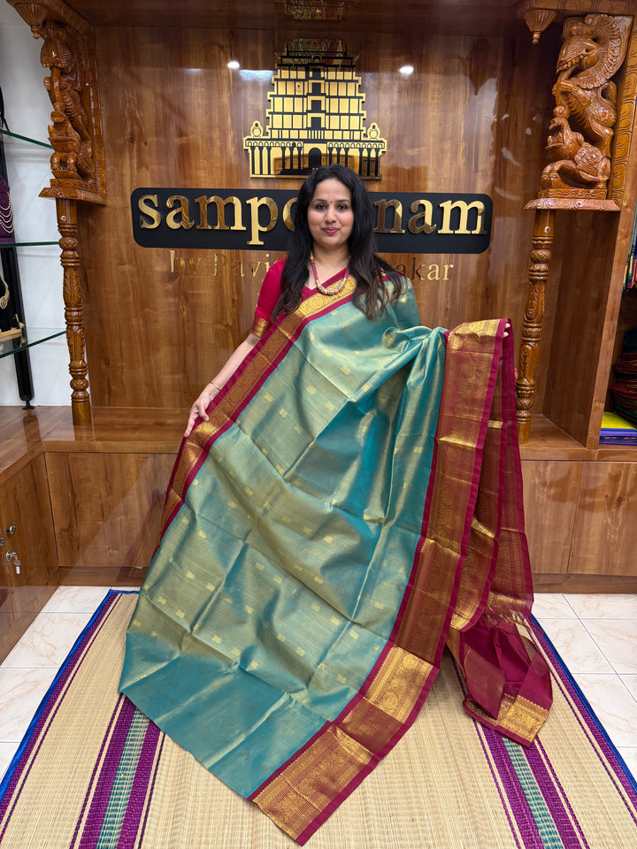Sage Green with Maroon , Rich Lotus Butta in the body , Traditional borders and rich Pallu Korvai Silk Cotton Saree