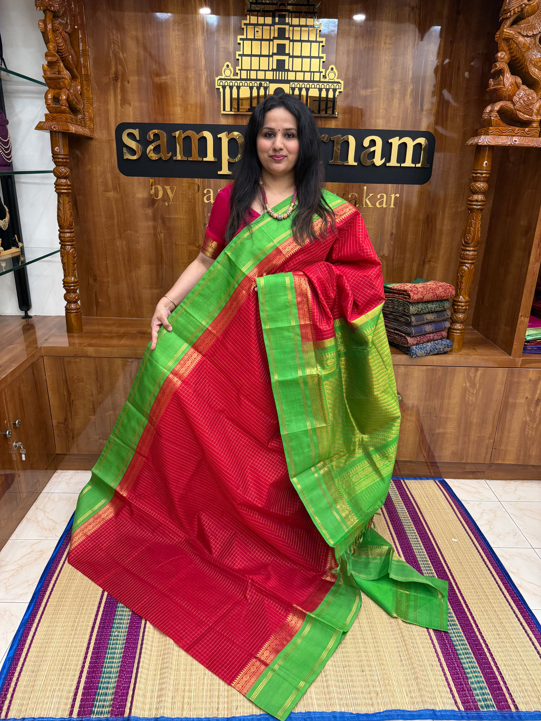 Red with Green , Rich Zari checks in the body , rettapet borders and rich Pallu Korvai Silk Cotton Saree