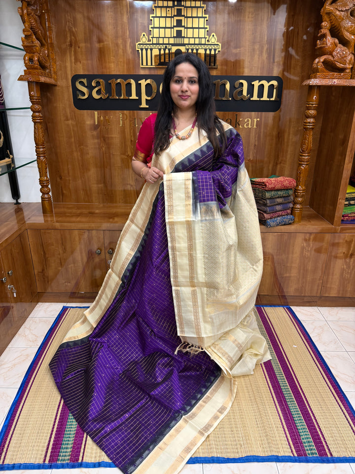 Purple with Offwhite , Rich Zari checks with Butta in the body , rettapet borders and rich Pallu Korvai Silk Cotton Saree