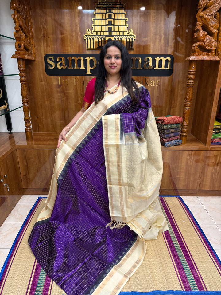 Purple with Offwhite , Rich Zari checks with Butta in the body , rettapet borders and rich Pallu Korvai Silk Cotton Saree