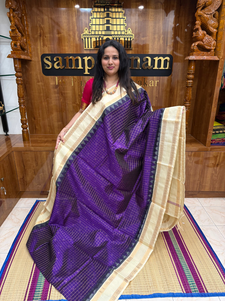 Purple with Offwhite , Rich Zari checks with Butta in the body , rettapet borders and rich Pallu Korvai Silk Cotton Saree