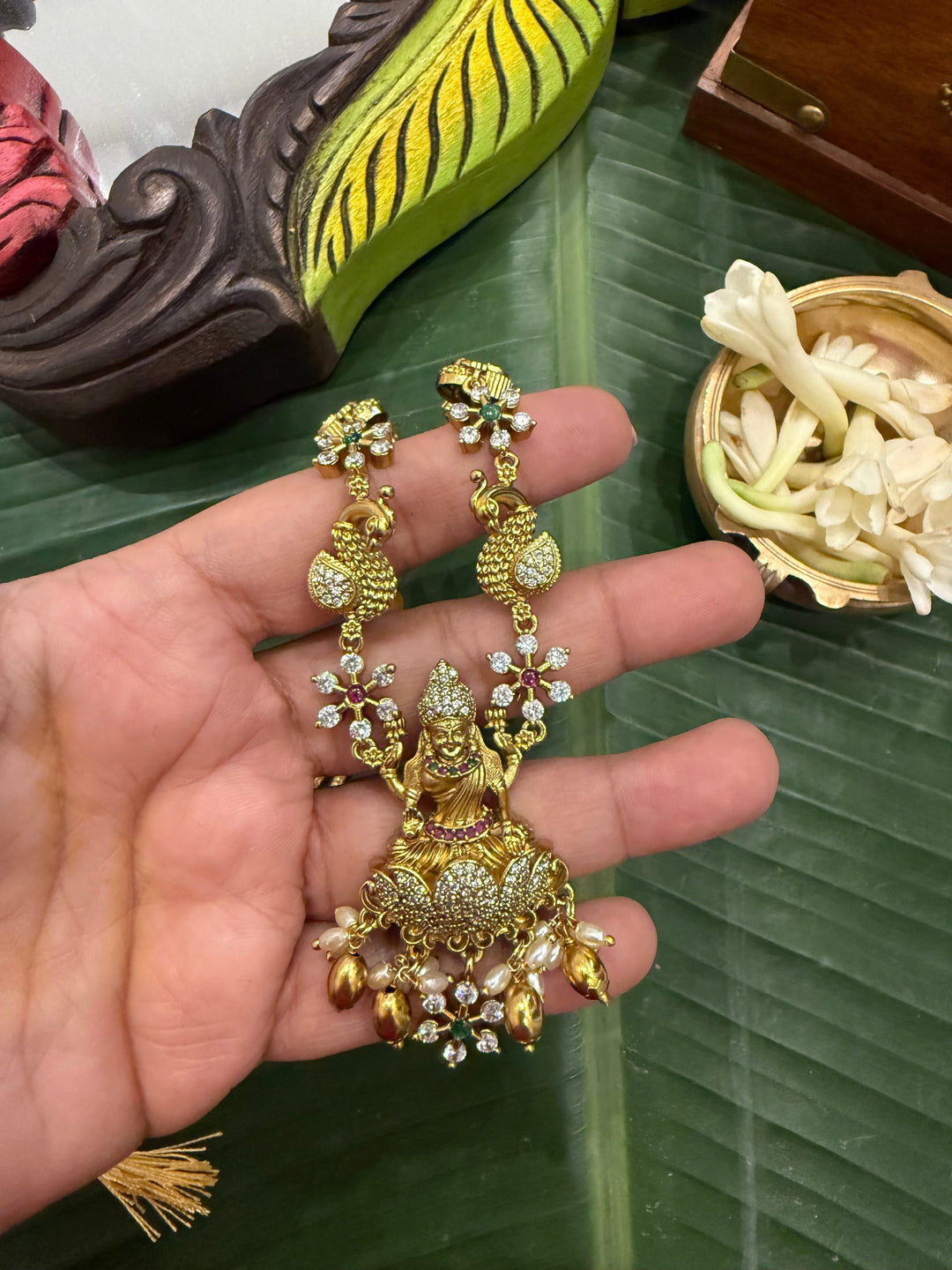 Divine Elegance , A traditional Necklace with a Mahalakshmi Pendant in red green and white stones with peacock detailing