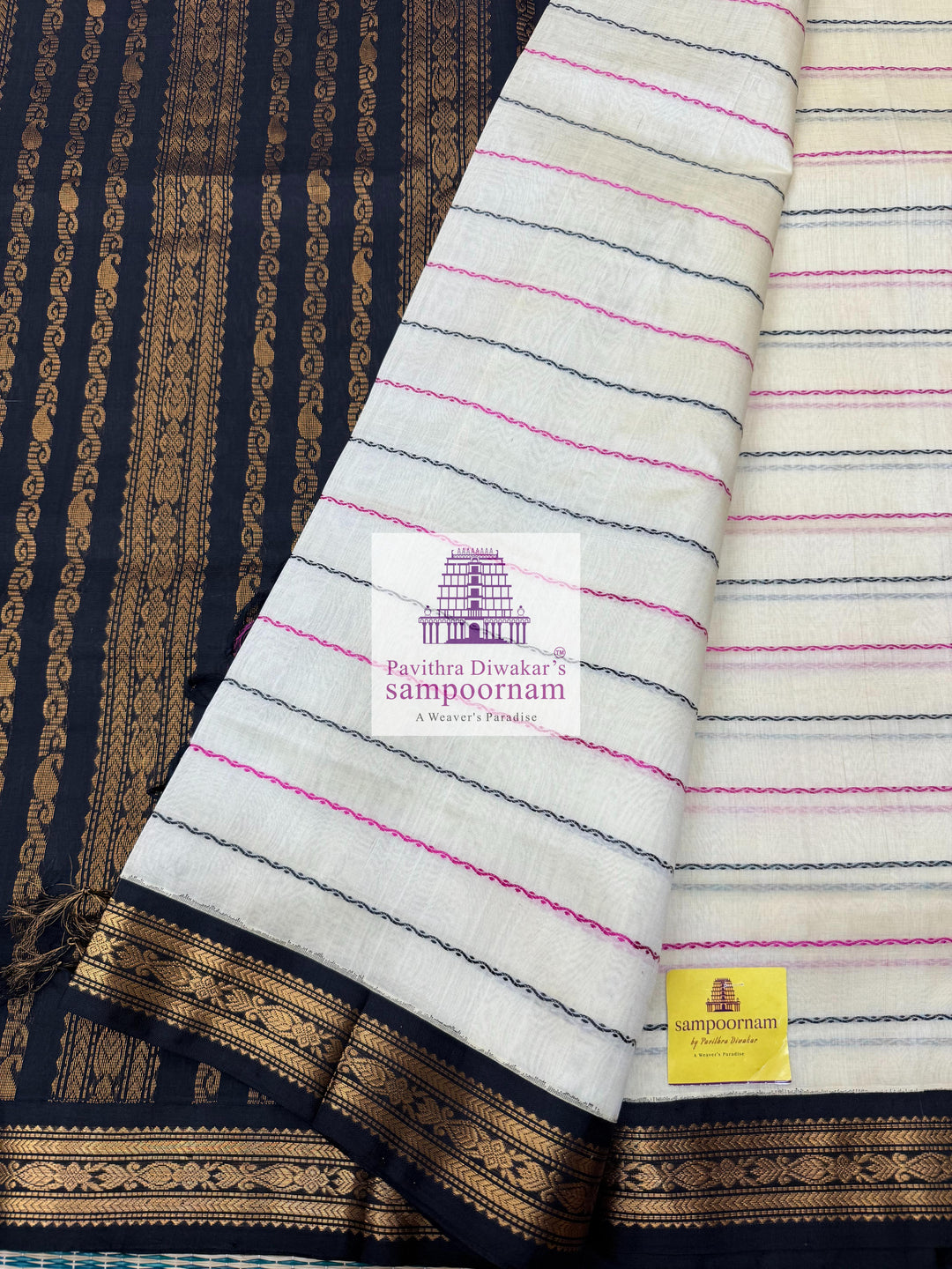 Offwhite with Black , traditional borders with Veldhari lines in the body and grand Pallu Korvai Silk Cotton Saree