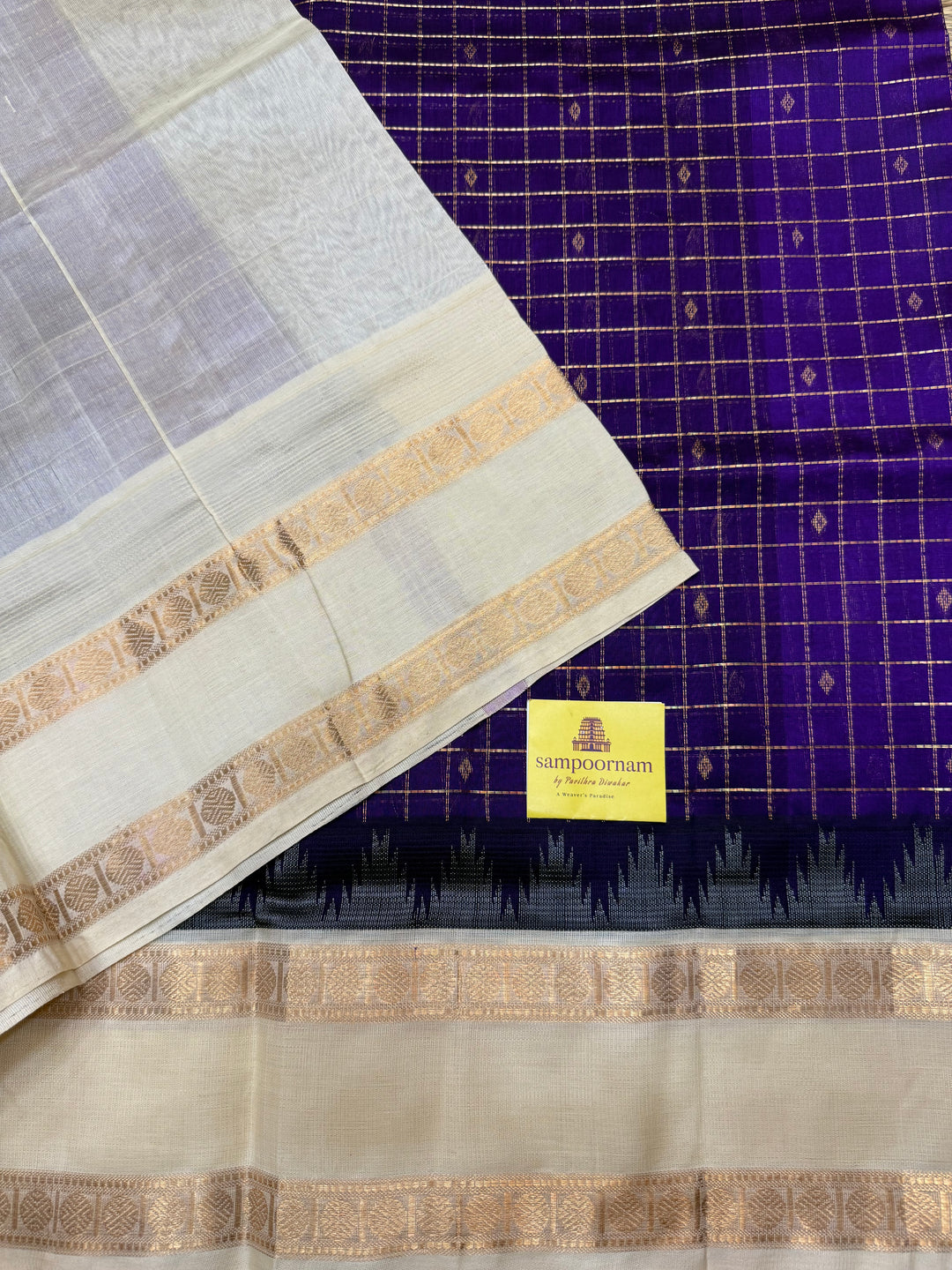 Purple with Offwhite , Rich Zari checks with Butta in the body , rettapet borders and rich Pallu Korvai Silk Cotton Saree