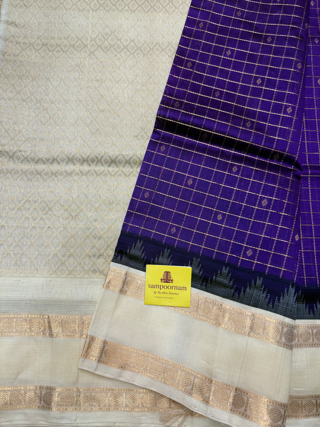 Purple with Offwhite , Rich Zari checks with Butta in the body , rettapet borders and rich Pallu Korvai Silk Cotton Saree