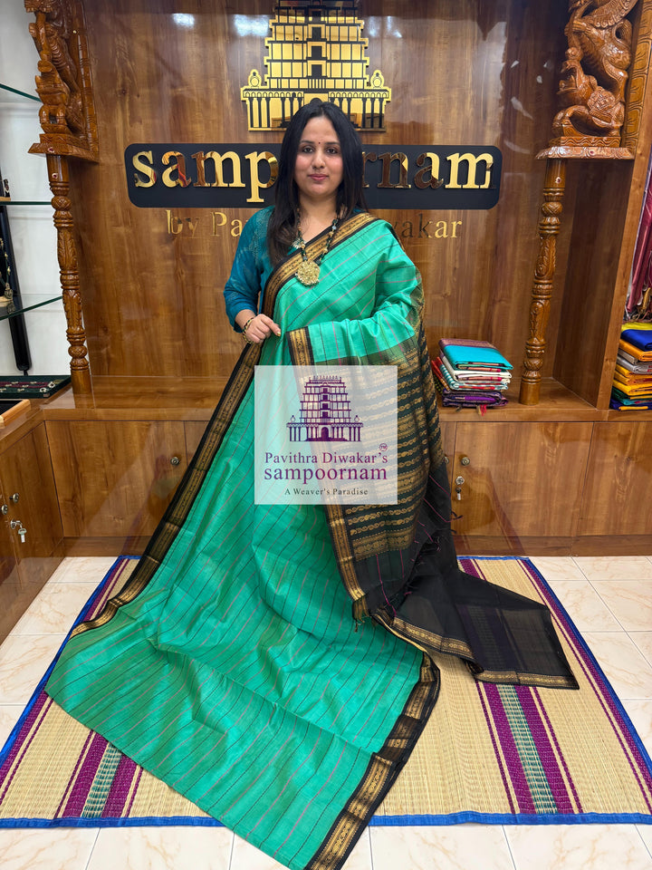 Ramar Green with Black  , traditional borders with Veldhari lines in the body and grand Pallu Korvai Silk Cotton Saree