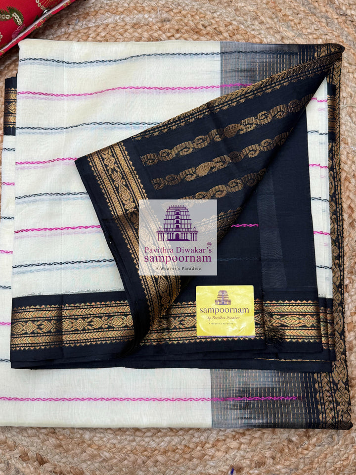 Offwhite with Black , traditional borders with Veldhari lines in the body and grand Pallu Korvai Silk Cotton Saree