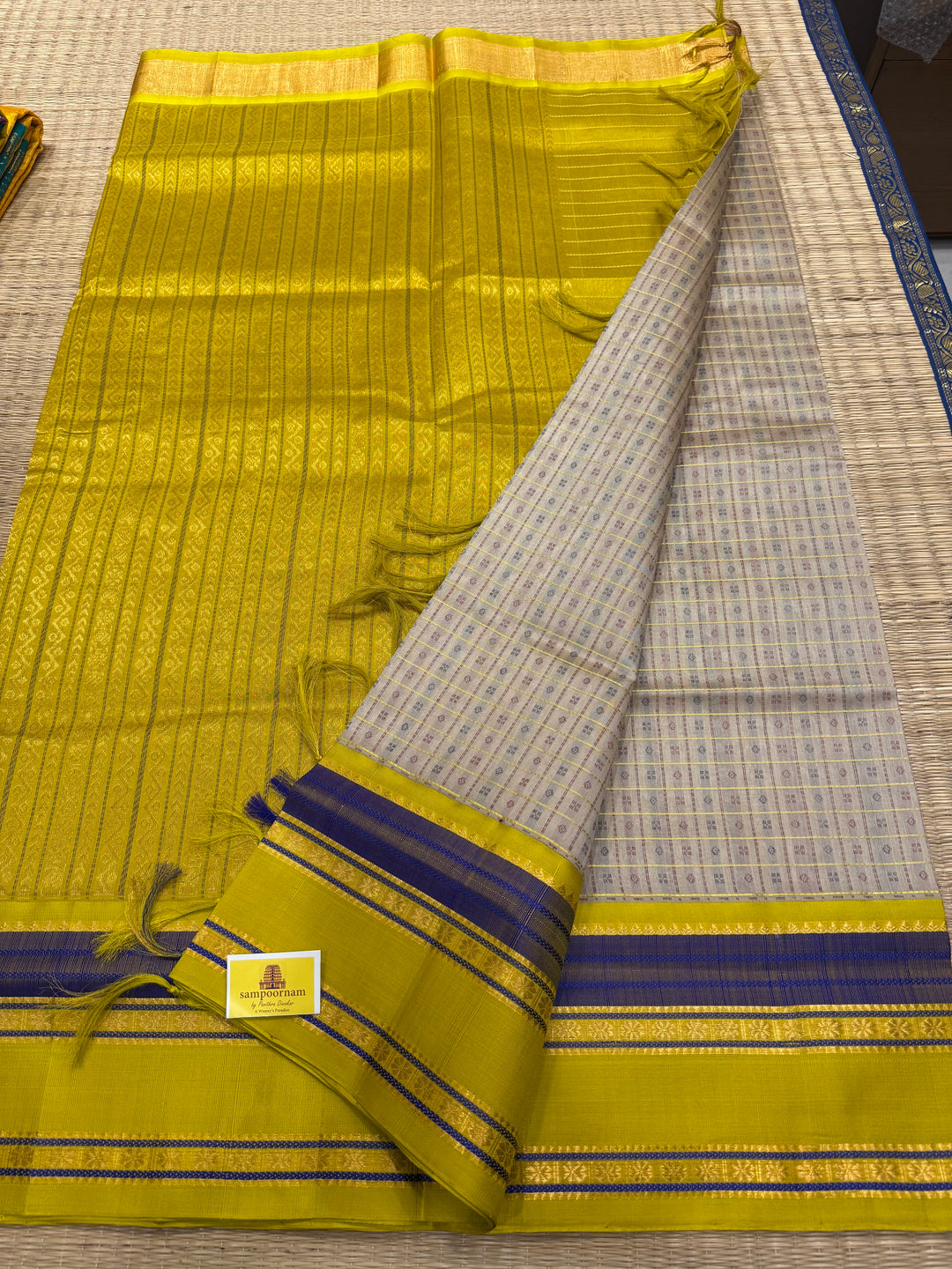 Offwhite with Lemon Yellow , Lakshadeepam Zari butta in the body and rettapet traditional borders and rich Pallu Korvai Silk Cotton Saree