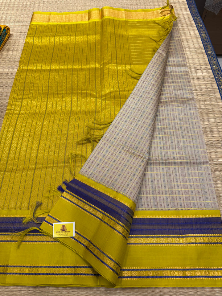 Offwhite with Lemon Yellow , Lakshadeepam Zari butta in the body and rettapet traditional borders and rich Pallu Korvai Silk Cotton Saree