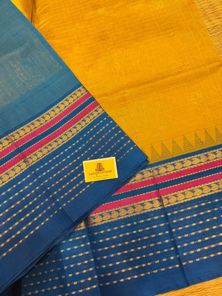 Yellow with Copper Sulphate Blue one side big border with Lakshadeepam butta , Zari butta in the body with Zari checks and grand Pallu Korvai Silk Cotton Saree