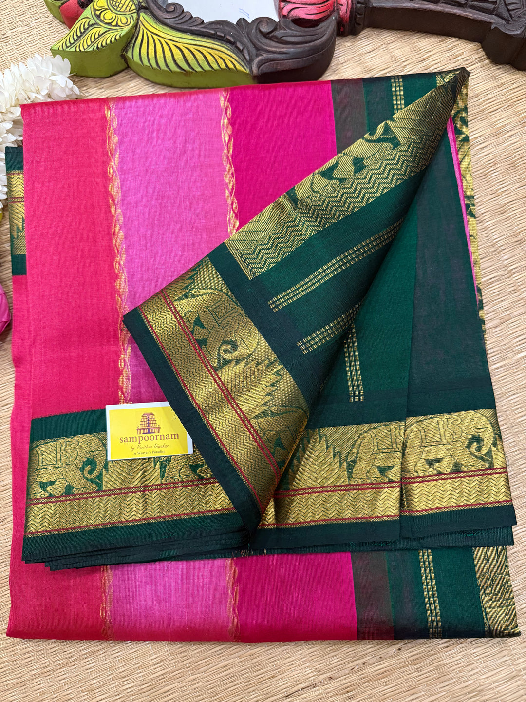 A Fusion of Colours Magenta and Pink with Green and Vertical Zari lines in the body with traditional borders and rich Pallu Korvai Silk Cotton Saree