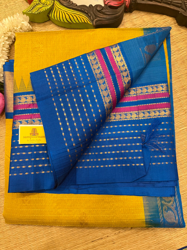 Yellow with Copper Sulphate Blue one side big border with Lakshadeepam butta , Zari butta in the body with Zari checks and grand Pallu Korvai Silk Cotton Saree