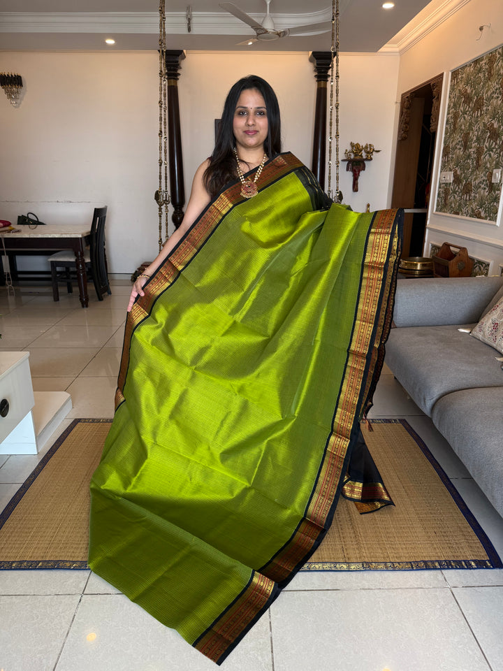 Leaf Green with Black , checks in the body , traditional borders and rich Pallu Korvai Silk Cotton Saree