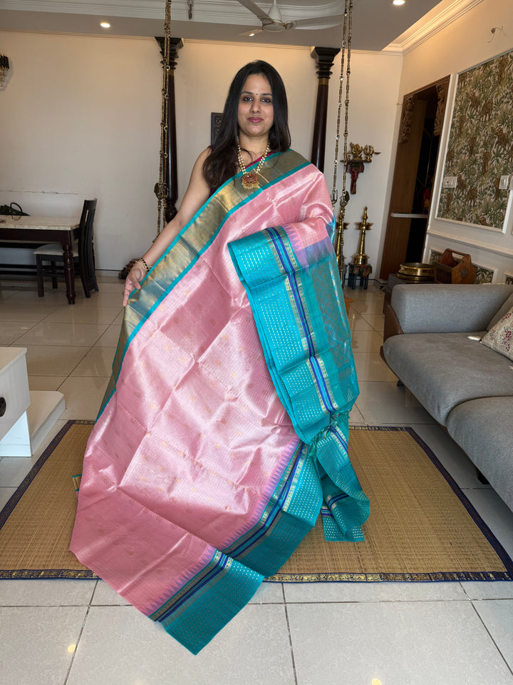 Baby Pink with Turquoise Blue one side big border with Lakshadeepam butta , Zari butta in the body with Zari checks and grand Pallu Korvai Silk Cotton Saree