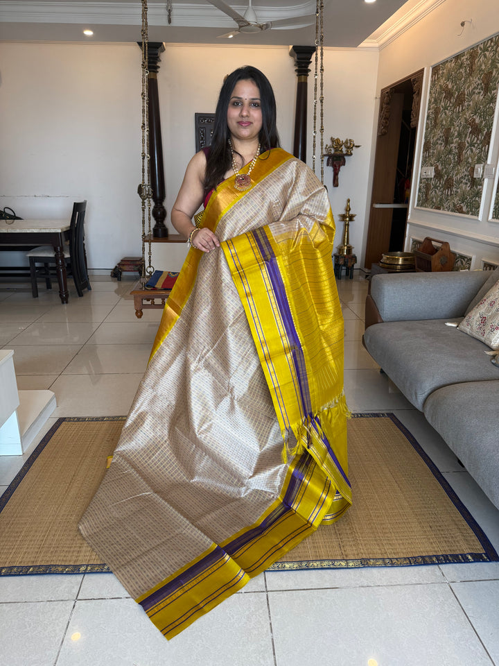 Offwhite with Lemon Yellow , Lakshadeepam Zari butta in the body and rettapet traditional borders and rich Pallu Korvai Silk Cotton Saree