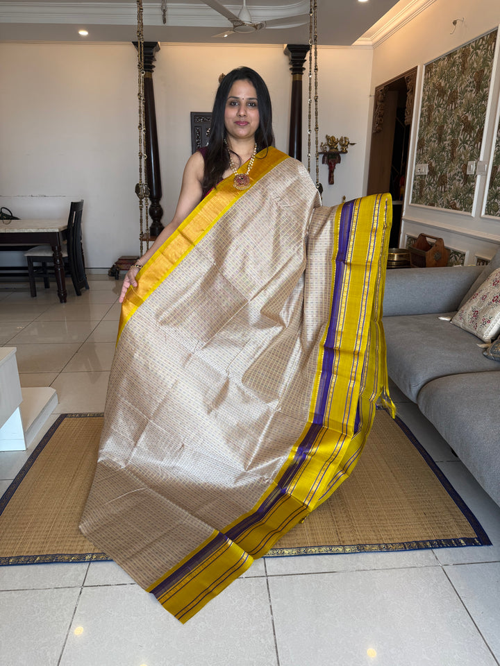 Offwhite with Lemon Yellow , Lakshadeepam Zari butta in the body and rettapet traditional borders and rich Pallu Korvai Silk Cotton Saree