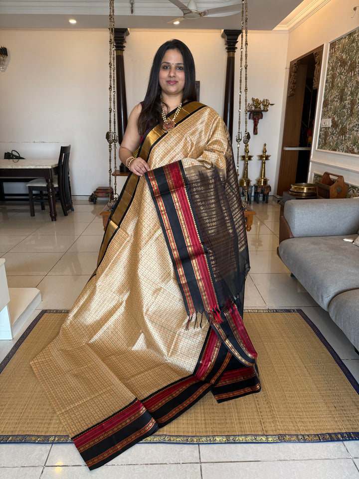 Biscuit and Black , Lakshadeepam Zari butta in the body and rettapet traditional borders and rich Pallu Korvai Silk Cotton Saree