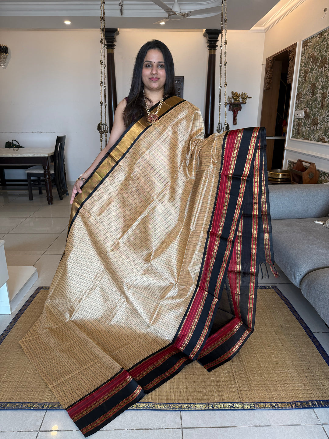 Biscuit and Black , Lakshadeepam Zari butta in the body and rettapet traditional borders and rich Pallu Korvai Silk Cotton Saree