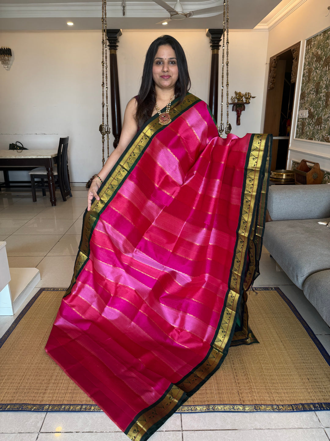 A Fusion of Colours Magenta and Pink with Green and Vertical Zari lines in the body with traditional borders and rich Pallu Korvai Silk Cotton Saree