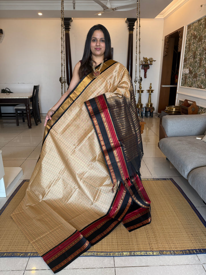 Biscuit and Black , Lakshadeepam Zari butta in the body and rettapet traditional borders and rich Pallu Korvai Silk Cotton Saree