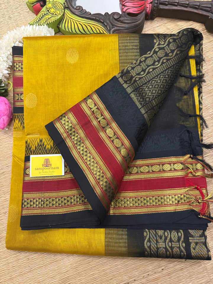 Mustard with Black ,rich Zari butta in the body , traditional rettapet temple thread borders and grand Pallu Korvai Silk Cotton Saree