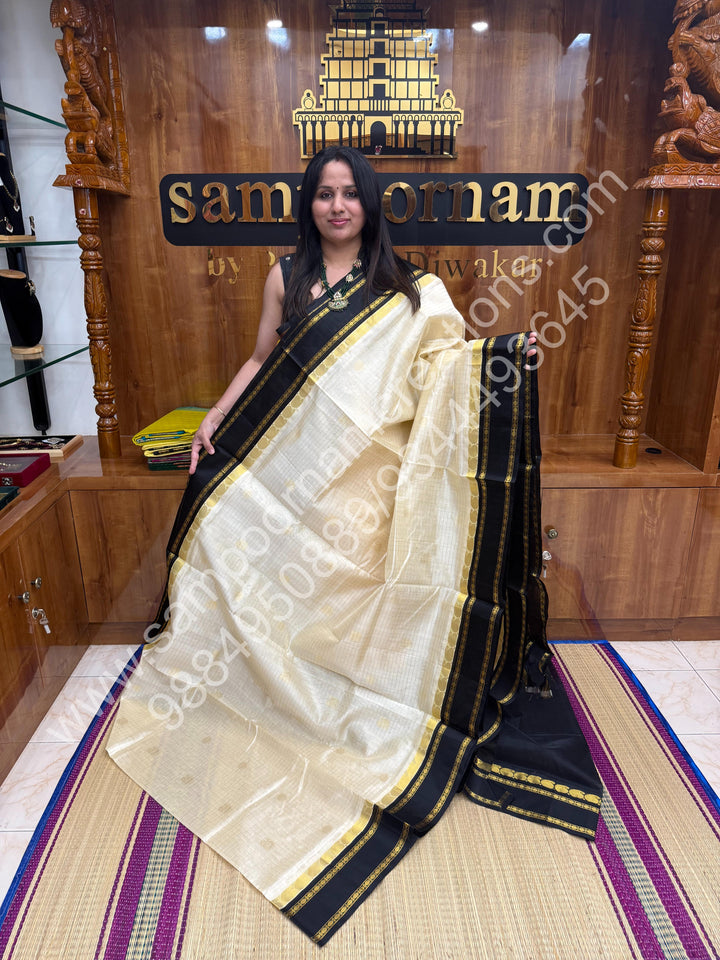 Cream with Black  , Zari checks , Mayil and Chakram rich butta in the body , rich borders with traditional Pallu Korvai Silk Cotton Saree