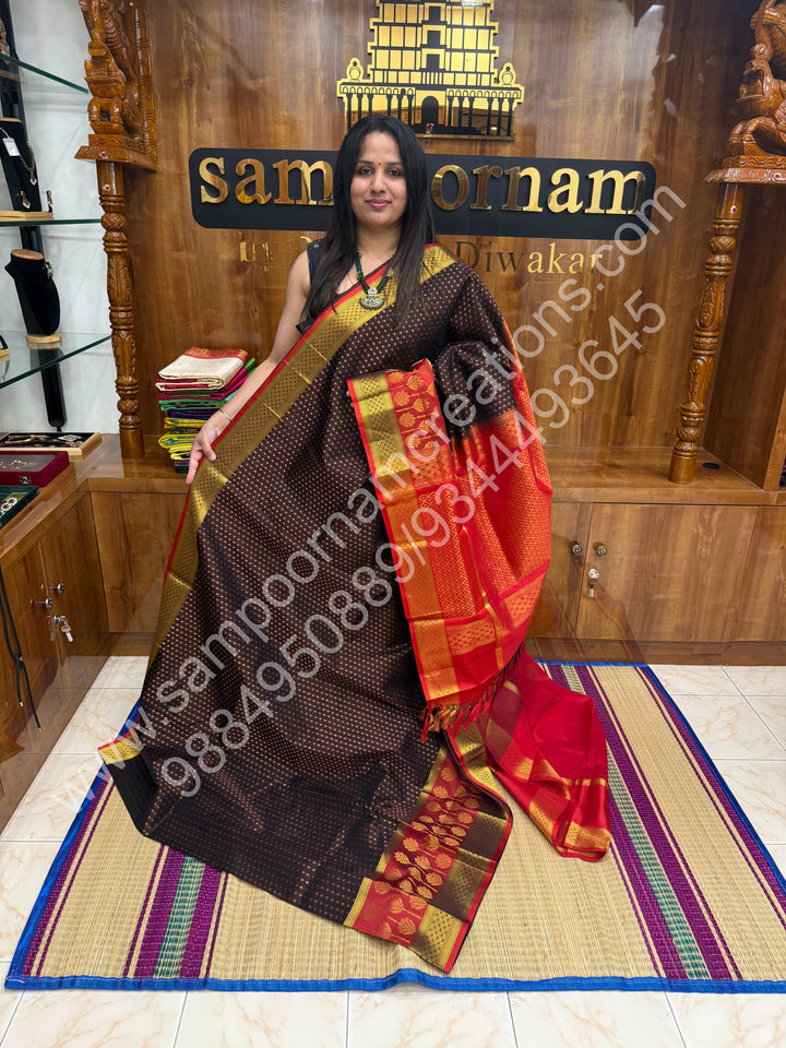 Brown with Red  , rich Zari Lakshadeepam butta in the body , one side long traditional Borders and Grand Pallu Korvai Silk Cotton Saree
