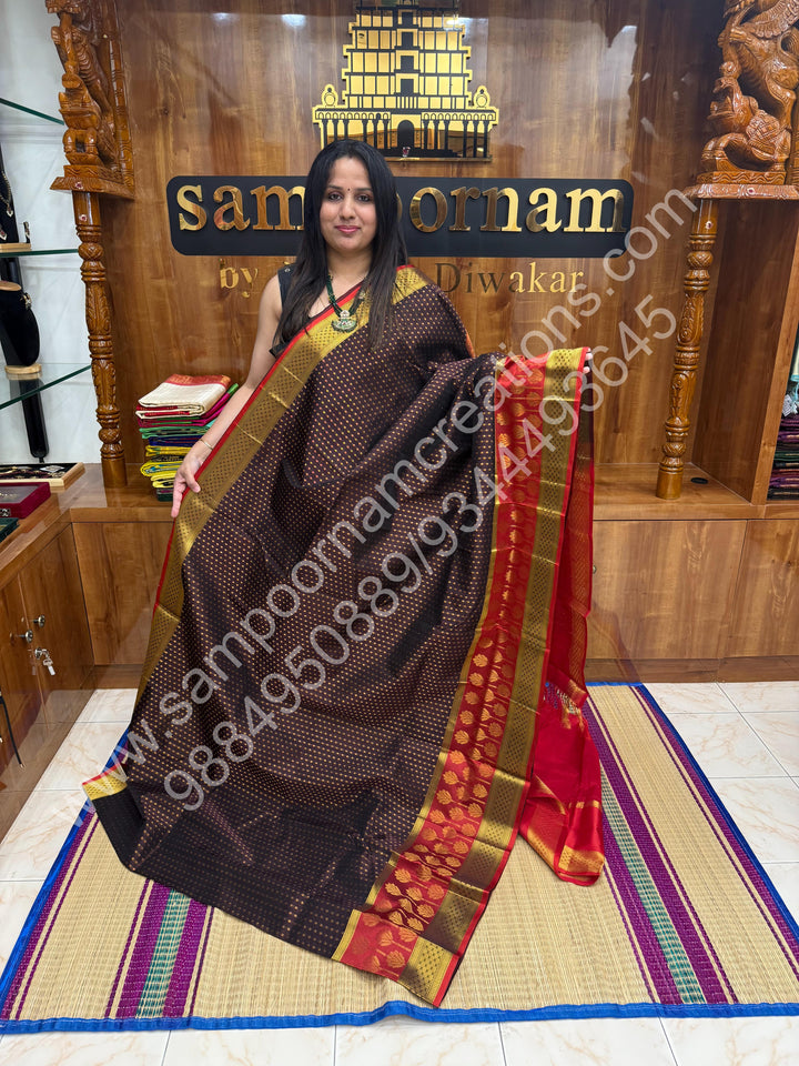 Brown with Red  , rich Zari Lakshadeepam butta in the body , one side long traditional Borders and Grand Pallu Korvai Silk Cotton Saree