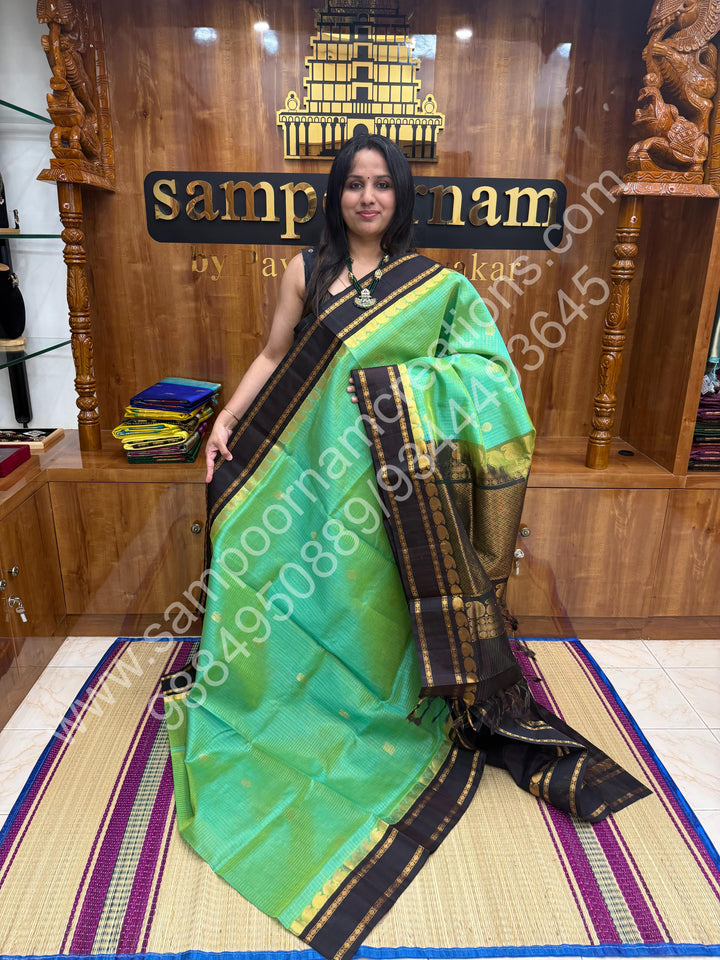Sea Green Gold with Dark Brown , Zari checks , Mayil and Chakram rich butta in the body , rich borders with traditional Pallu Korvai Silk Cotton Saree