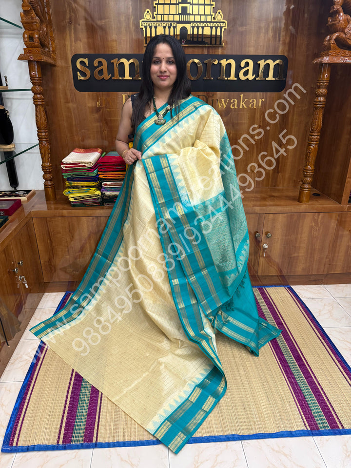 Offwhite with Turquoise Blue  , rich Zari checks in the body , Temple designs with Rettapet Borders and Grand Pallu Korvai Silk Cotton Saree