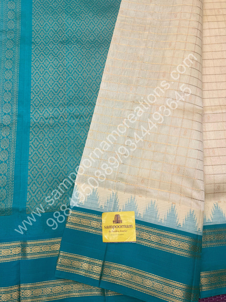 Offwhite with Turquoise Blue  , rich Zari checks in the body , Temple designs with Rettapet Borders and Grand Pallu Korvai Silk Cotton Saree