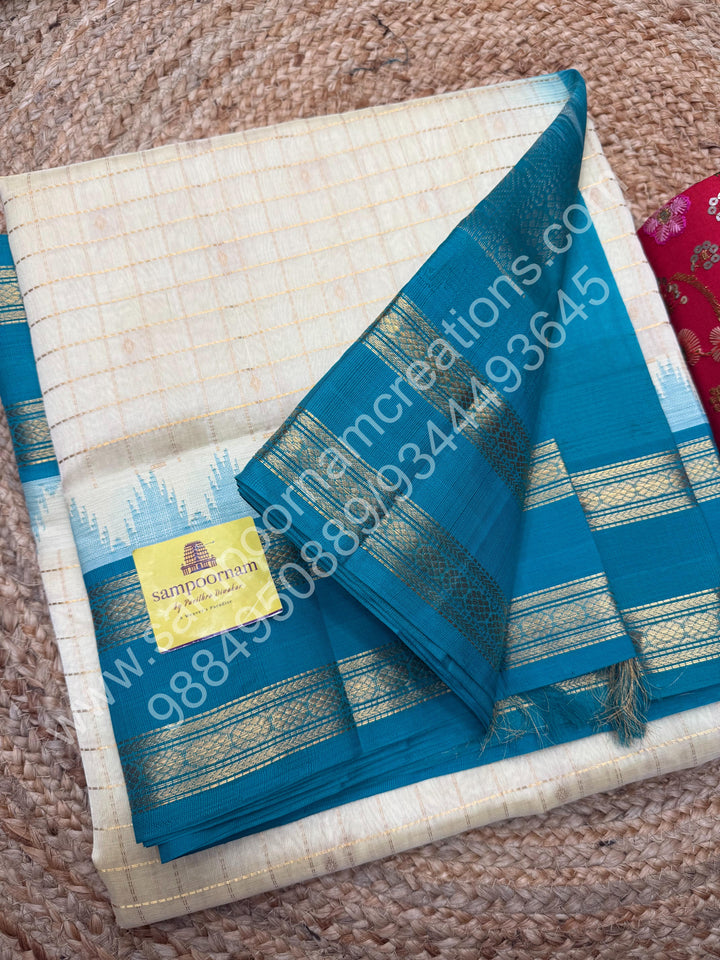 Offwhite with Turquoise Blue  , rich Zari checks in the body , Temple designs with Rettapet Borders and Grand Pallu Korvai Silk Cotton Saree