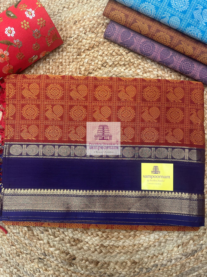 Reddish Orange with Purple  , Annam and Chakram thread butta in the body  , rettapet border and Plain  Pallu Chettinad Cotton Saree