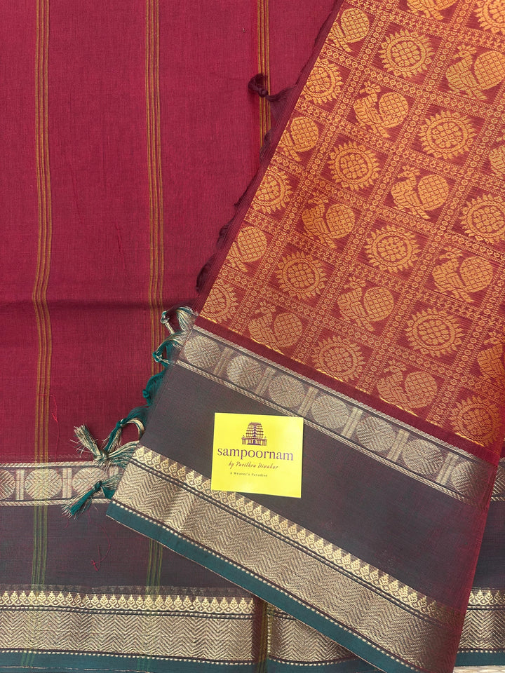 Brick Red with Manthulir Green  , Annam and Chakram thread butta in the body  , rettapet border and Plain Pallu Chettinad Cotton Saree