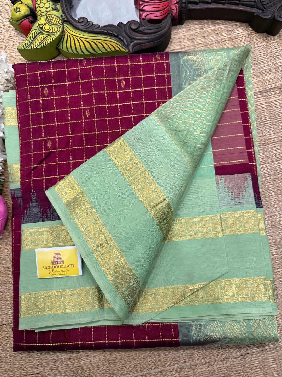 Dark Maroon with Mint Green , rich zari butta in the body , traditional rettapet border and rich Pallu Korvai Silk Cotton Saree