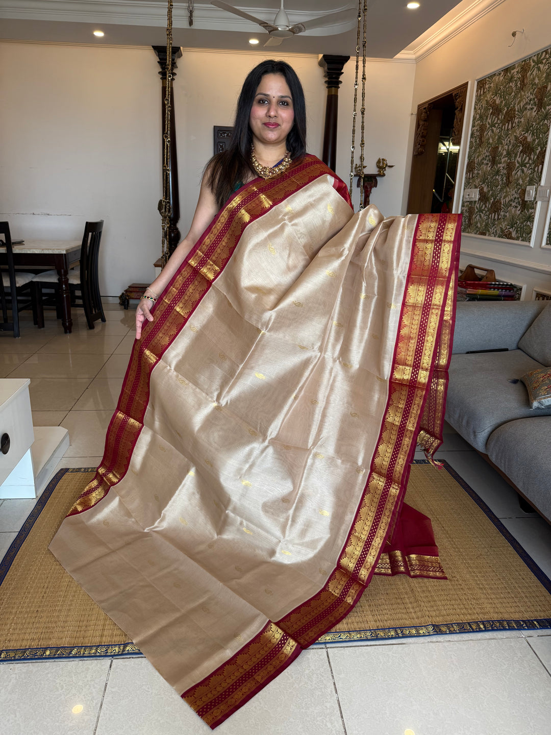 Beige with Red , rich mango zari butta in the body with traditional borders with Lakshadeepam butta and rich Pallu Korvai Silk Cotton Saree
