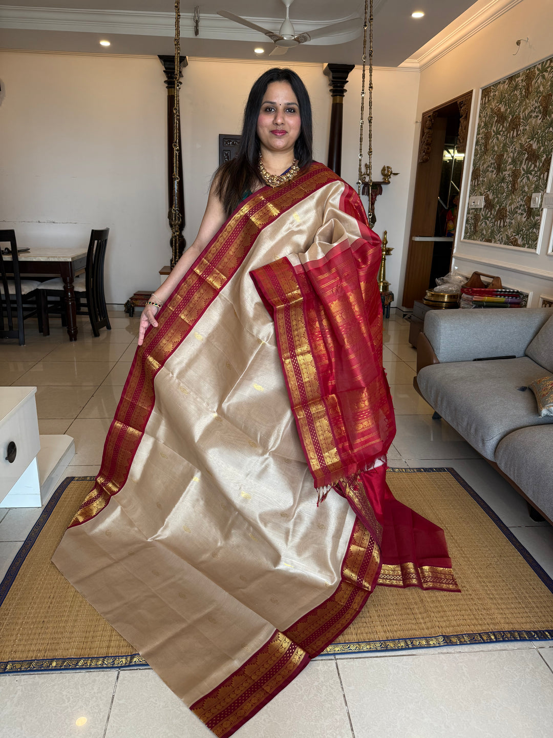 Beige with Red , rich mango zari butta in the body with traditional borders with Lakshadeepam butta and rich Pallu Korvai Silk Cotton Saree