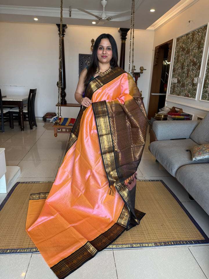 Peachish Pink with Black Vairaoosi Zari Lines in the body traditional borders and rich Pallu Korvai Silk Cotton Saree