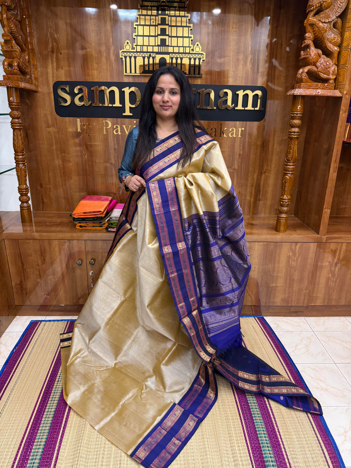 Light Gold with Blue , Rich Zari butta in the body , Rettapet borders and rich Pallu Korvai Silk Cotton Saree