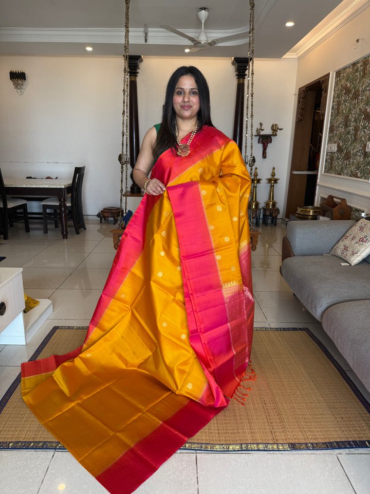 Manjal with Reddish Pink , rich zari checks in the body , vairaoosi lines in the border and rich Pallu , pure soft silk saree